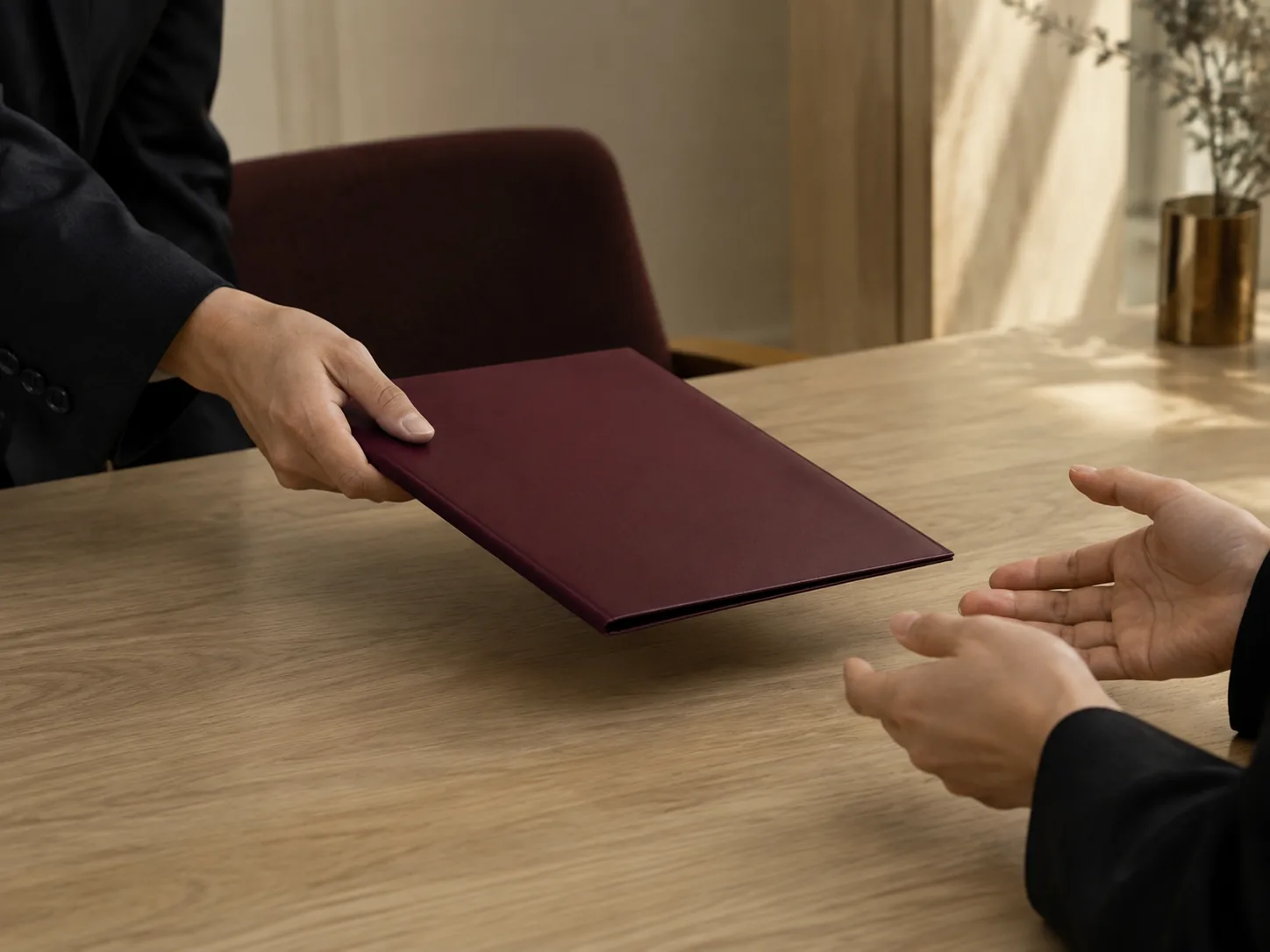 Home A document folder being pushed across a table