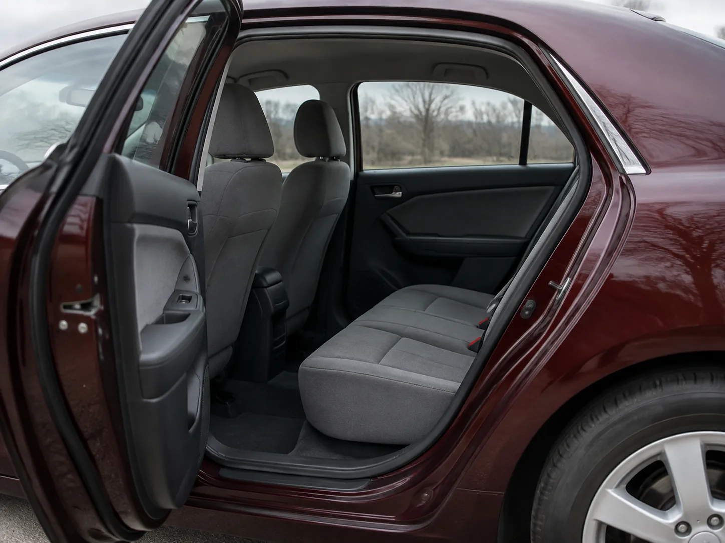 Home The open door of a used car showing a plain grey interior